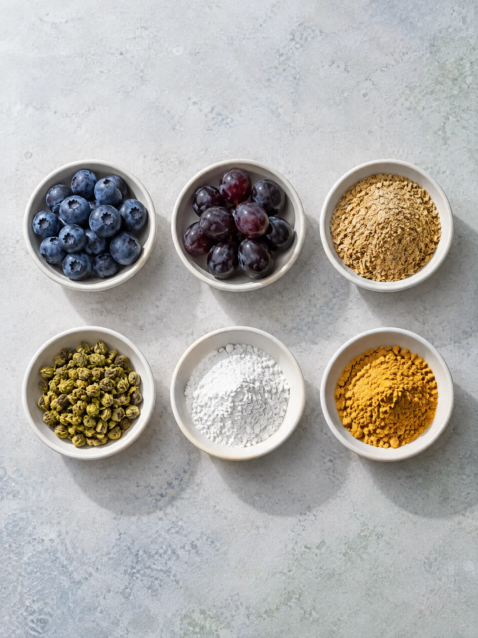 Six supplement ingredients laid out in bowls